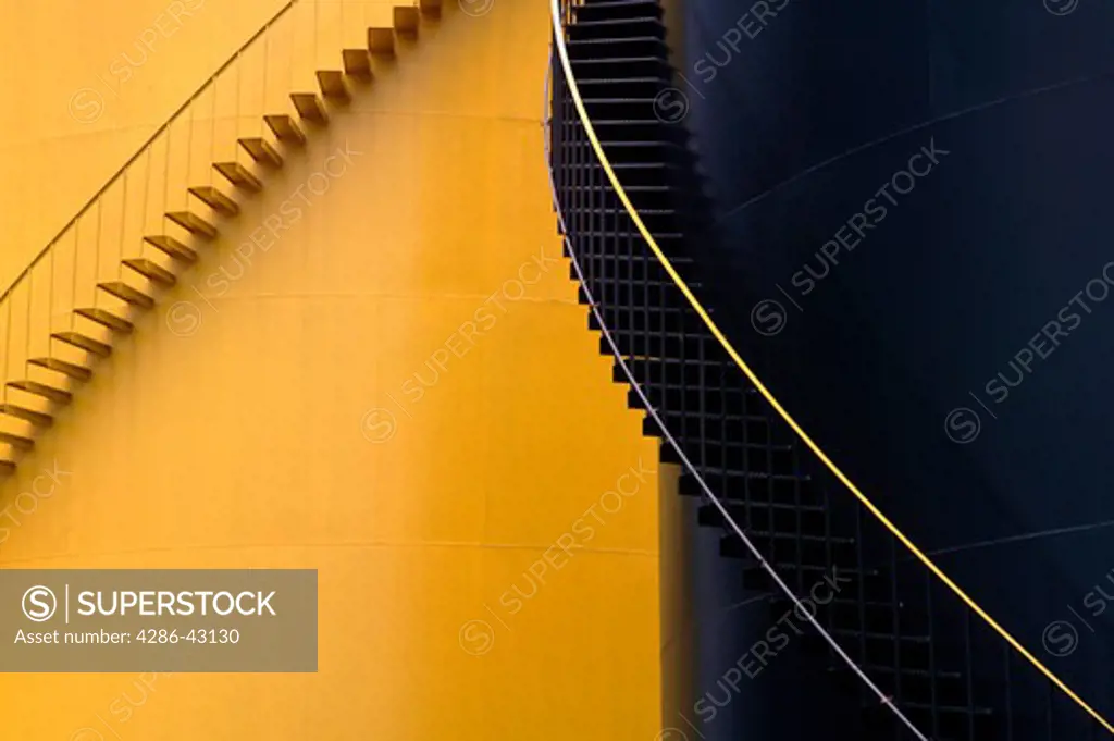 Black and yellow colored stairwell along the sides of oil storage tanks, Oyster Bay, NY.