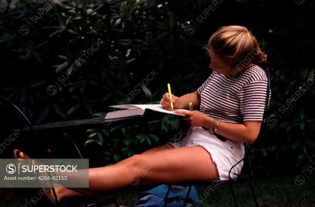 An undergraduate female college student at work on an assignment in Northeastern University. 