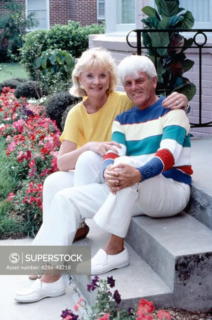Senior couple sitting on front steps