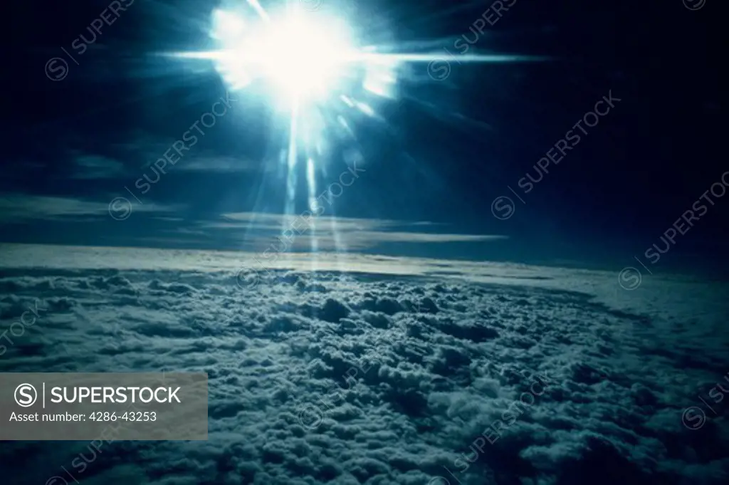 Aerial view of the sun above the clouds taken at about 50,000 feet. 