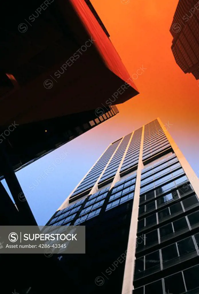 Looking up at skyscrapers and orange sky, Philadelphia, PA.