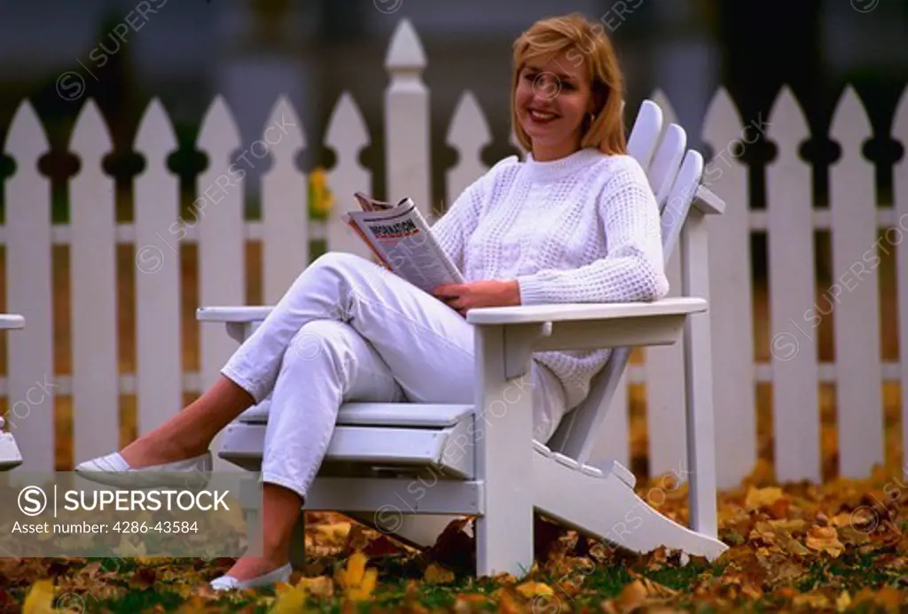 Woman in front of white picket fenc, MR