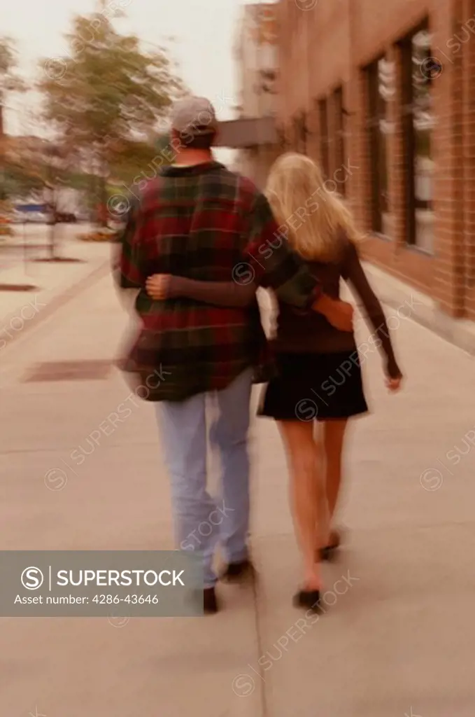 Young couple walking down the street
