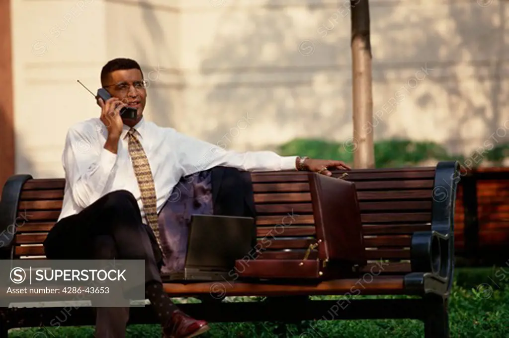 Business man talking on cellular phone outdoors