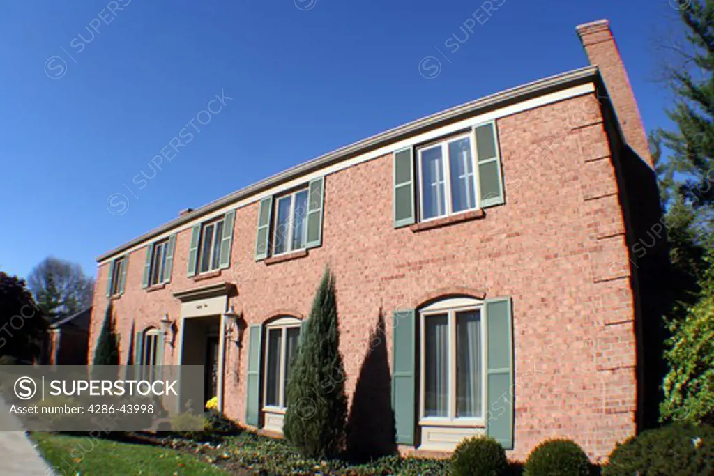 Brick home in upscale neighborhood, wide angle shot