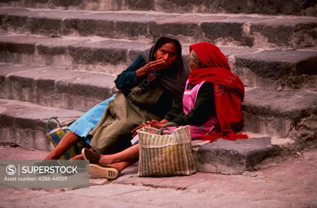CENTRAL AMERICAN LADIES RESTING ON STEPS