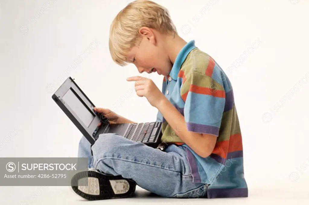 Young boy using laptop computer