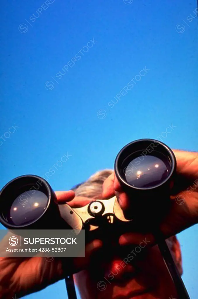 Man looking through binoculars.