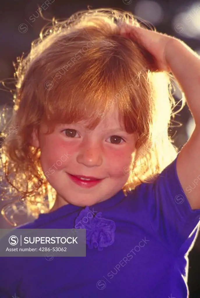 Portrait of young red-haired girl with rosy cheeks.