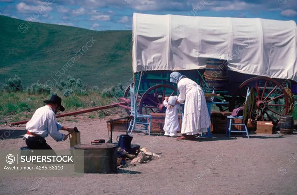 Actors portray early American settlers traveling by covered wagon at the Interpretive Center, Oregon Trail, Oregon.