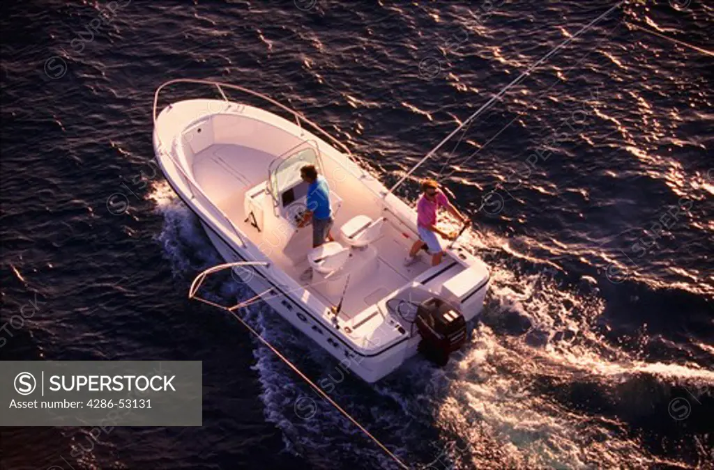 Aerial view of two men on sport fishing boat trolling offshore in the Gulf of Mexico.
