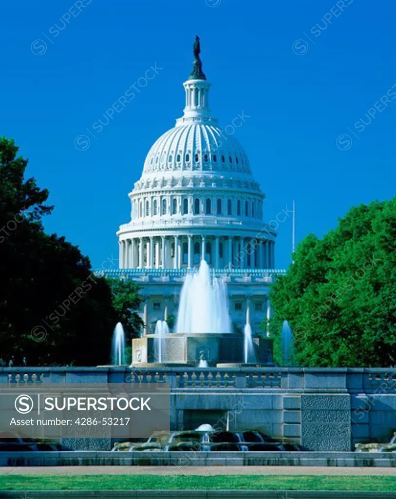 The dome of the U.S. Capitol in Washington D.C. seen from the north behind a decorative fountain.