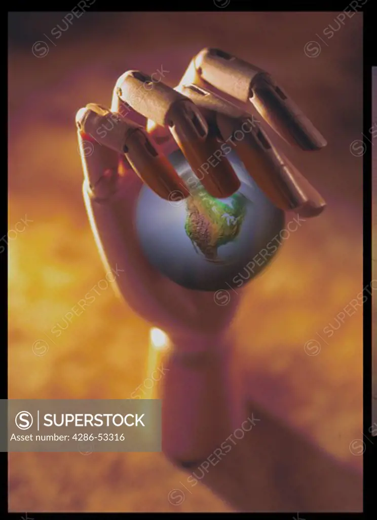 Wooden hand holding globe.