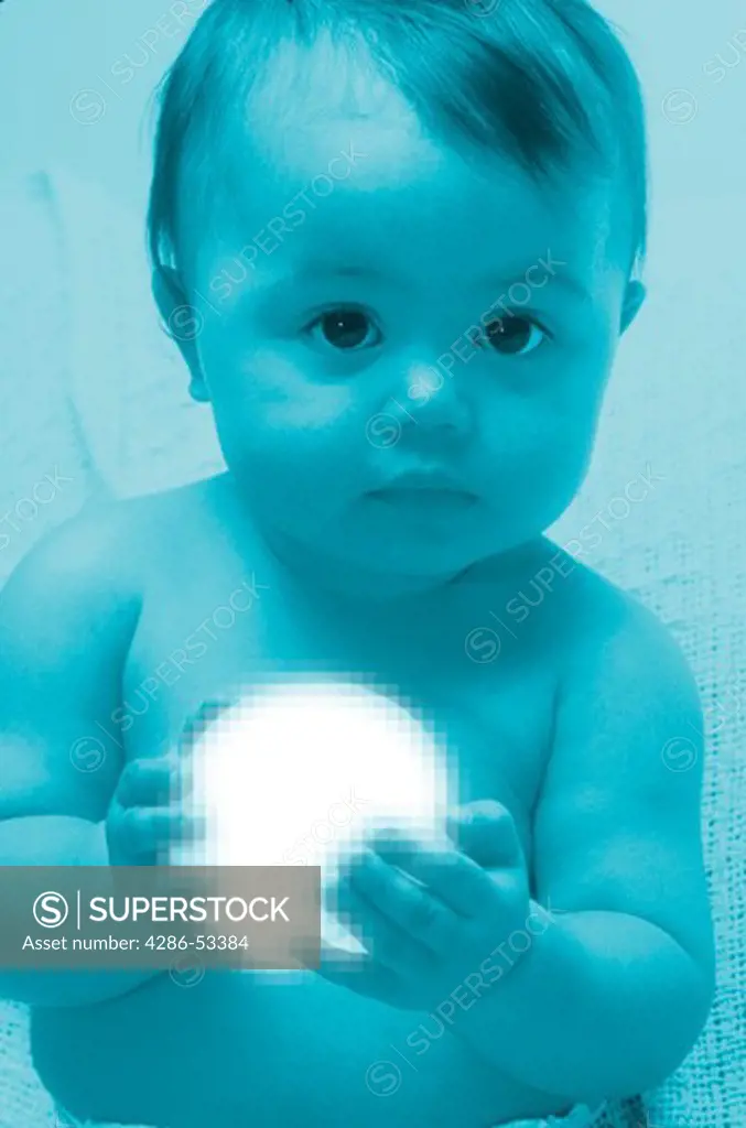 Portrait of a young baby holding a glowing sphere in its hands.