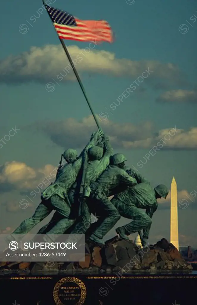 Iwo Jima Memorial showing statues of Marine Corps soldiers with the American flag, with the Washington Monument in the background.