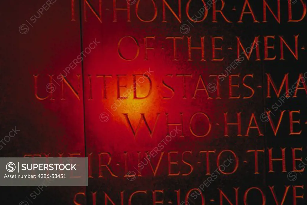 Close-up of sun reflection on words inscribed on the Iwo Jima Marine Corps Memorial.