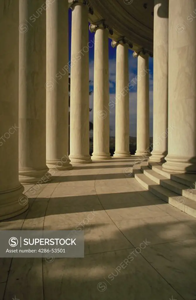 Marble columns in circular formation around building.