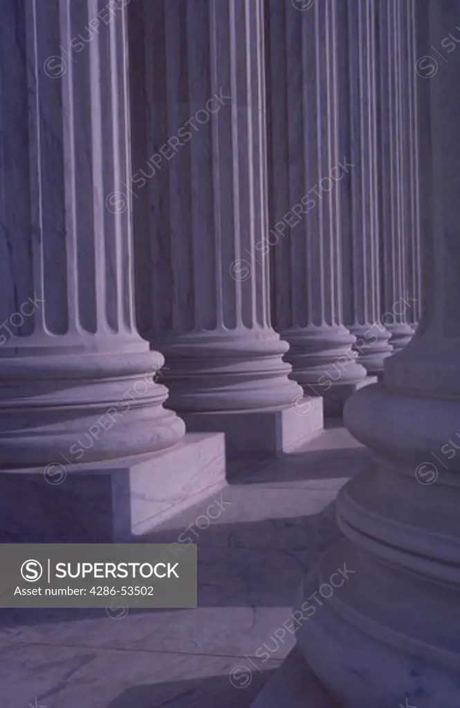 Marble columns in circular formation around building.