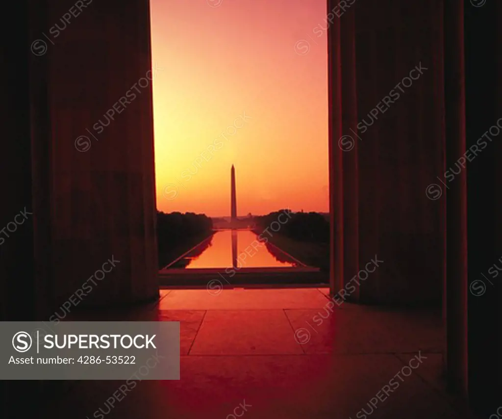 View of the Washington Monument and the reflecting pool through the columns of the Lincoln Memorial at dusk, Washington, DC.
