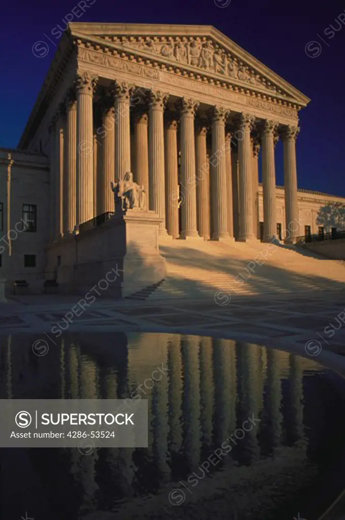 View of the statue, columns and facade of the U.S. Supreme Court building with fountain pool in the foreground, Washington, DC.