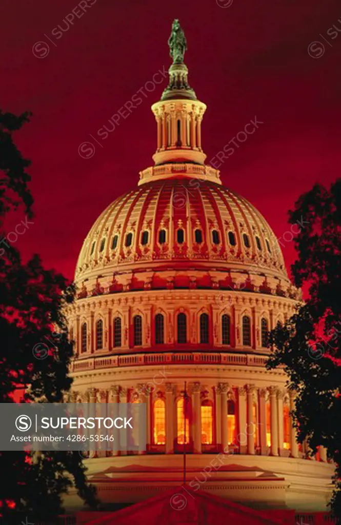 U.S. Capitol dome with red sky at sunset, Washington, DC.