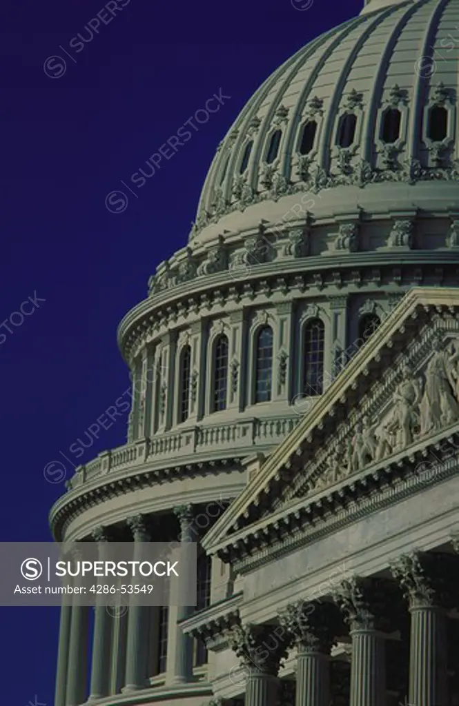 U.S. Capitol dome and facade against blue sky, Washington, DC.