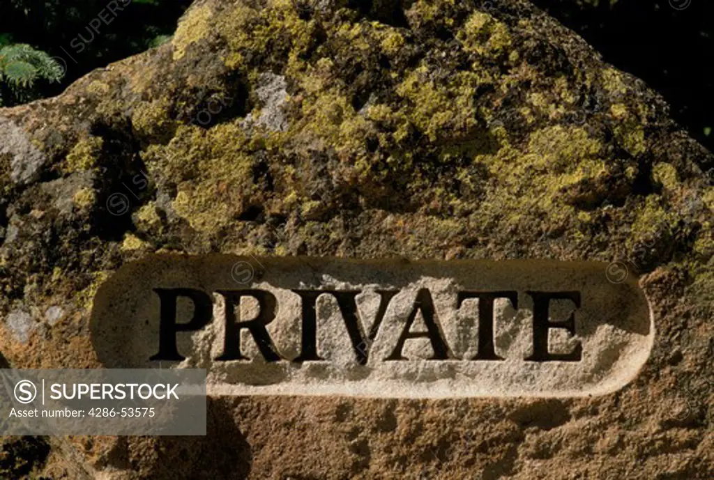 Private carved deeply into a boulder outdoors.