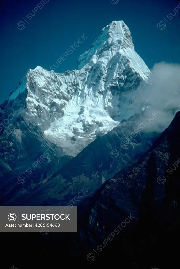 The snow covered peak of Ama Dablam, Khumbu-Himal, Nepal rising up against a blue sky.
