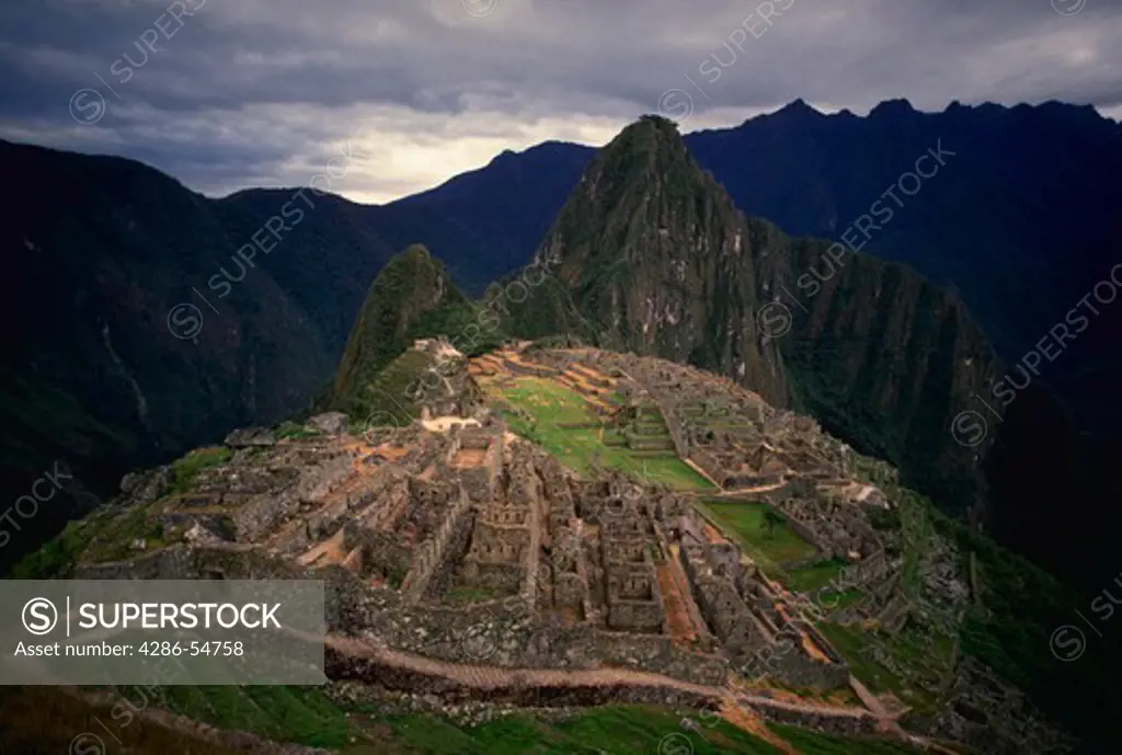 Inca ruins at Machu Picchu in Peru. This view from the cemetery shows the pre-Columbian terraced stonework of the fortress city. At rear is Huayna Picchu mountain.