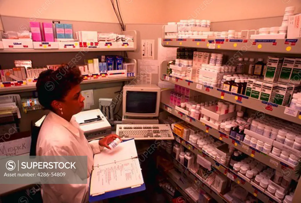 Employee checks medicine in the 'Formulary' at the Primus Clinic in Burke Virginia. (model released)