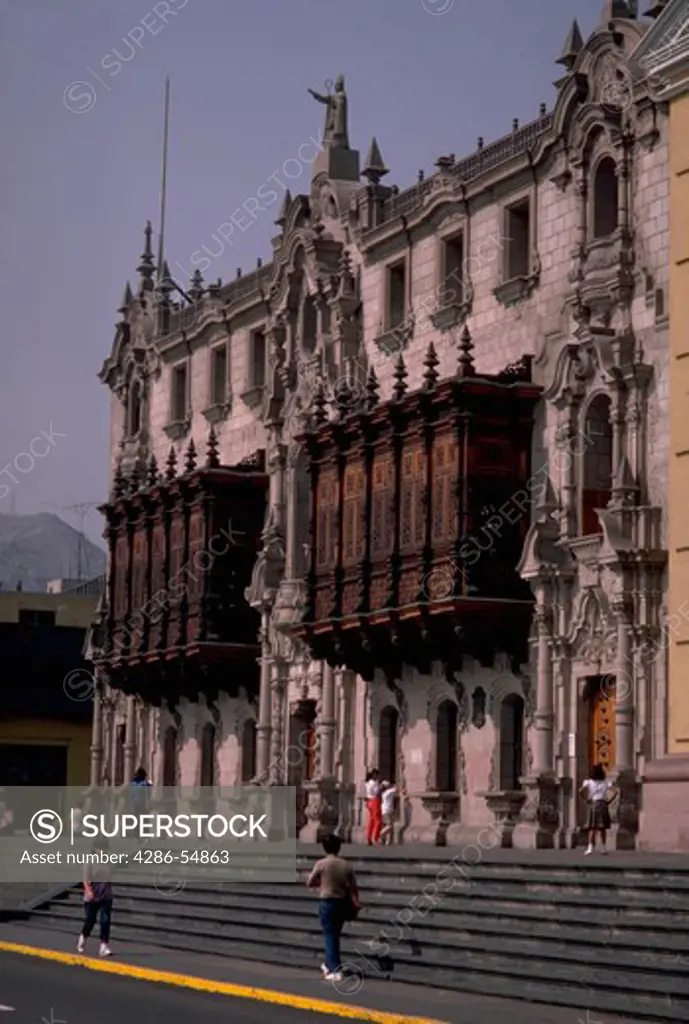 Colonial wooden balconies are attached to the front of the Archbishops Palace in the Plaza de Armas, Lima, Peru.