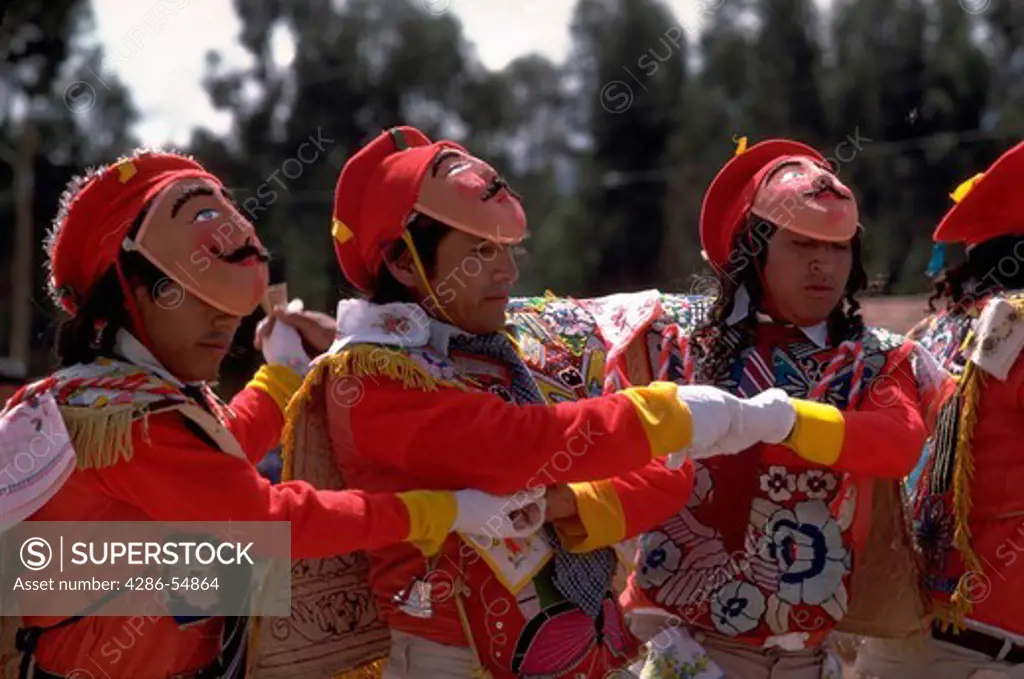 Costumed dancers join arms in the Chonguinada dance in a village near the mountain city of Huancayo, Junin Department, Peru.