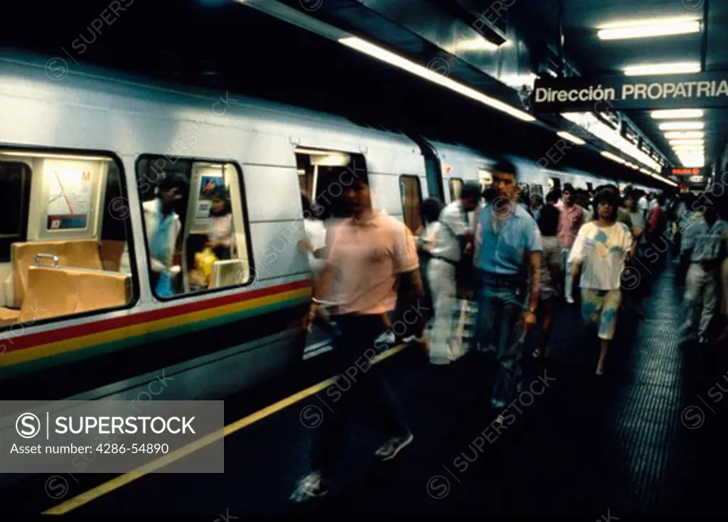 Passengers move along platform as they exit a train in Caracas, Venezuela's modern Metro system.