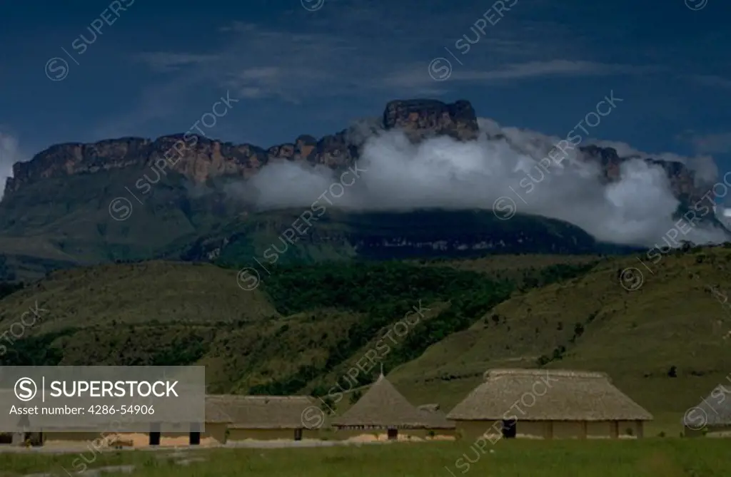 Auyan tepui mountain rises up above the Camp Kavak tourist village in Canaima National park, Venezuela.