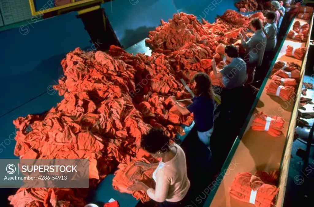 Workers sort shop rags in a commercial laundry in Syracuse, New York.