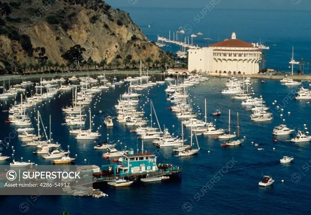 Pleasure boats fill the harbor with the Casino at rear in the City of Avalon, Catalina Island, California.