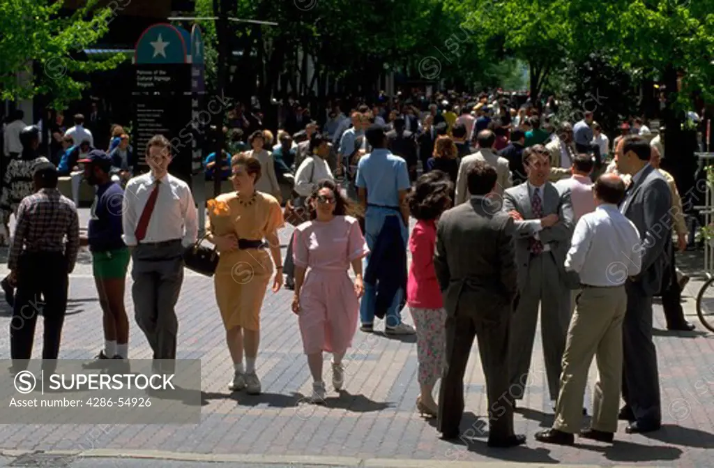 Pedestrians stroll at noon on sunny day on the Market Street Mall in downtown Wilmington, Delaware.
