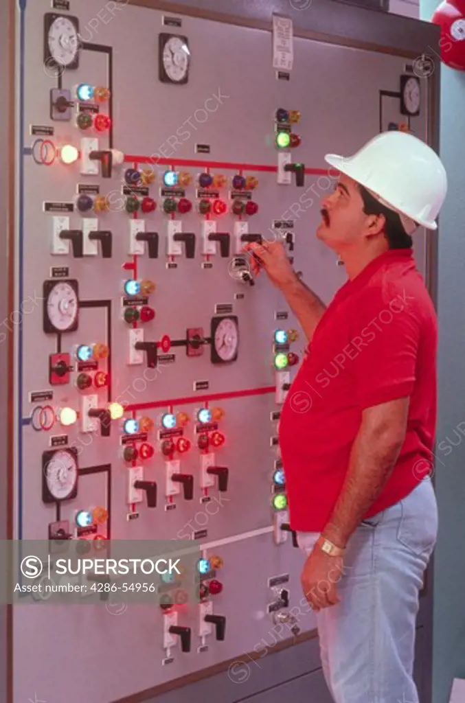 Lagoven Oil Company worker checks control panel in control room of gas compression plant on Lake Maracaibo, Zulia State, Venezuela.