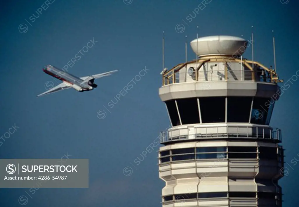 Commercial passenger jetliner passes by control tower after take off from Reagan National Airport, Arlington, Virginia and Washington, DC.
