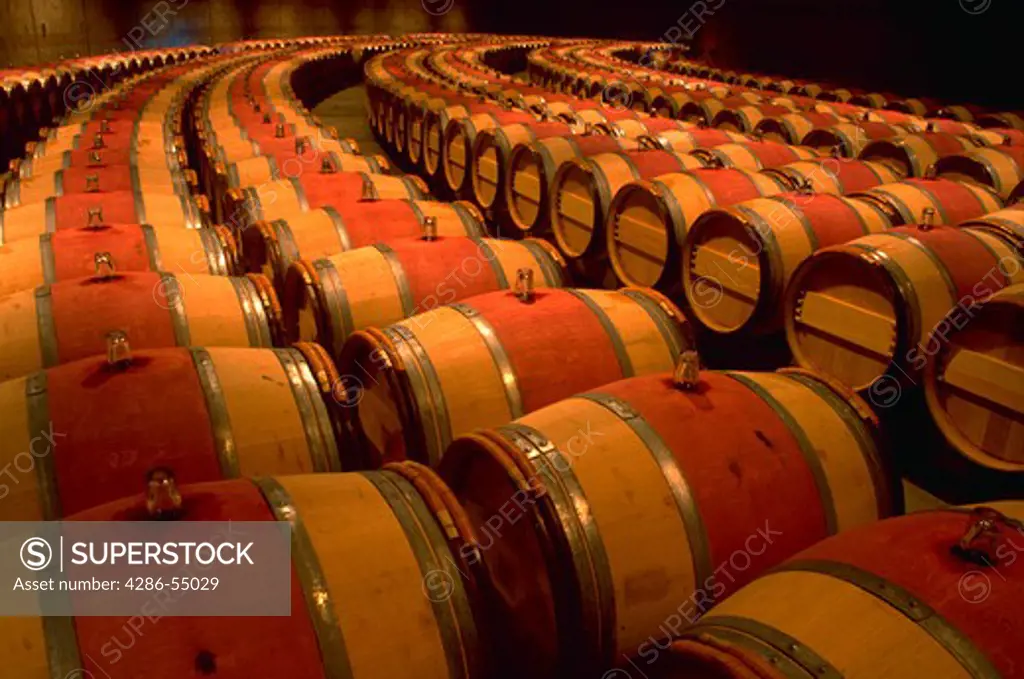 Rows of french oak barrels for aging wine at Opus One Winery, Napa Valley, California.