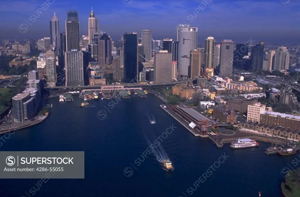 Aerial view of boats and ferry wharves in Sydney Cove and Circular Quay with Sydney skyline, Sydney, Australia. Sydney is the site of the 2000 Olympic Games.