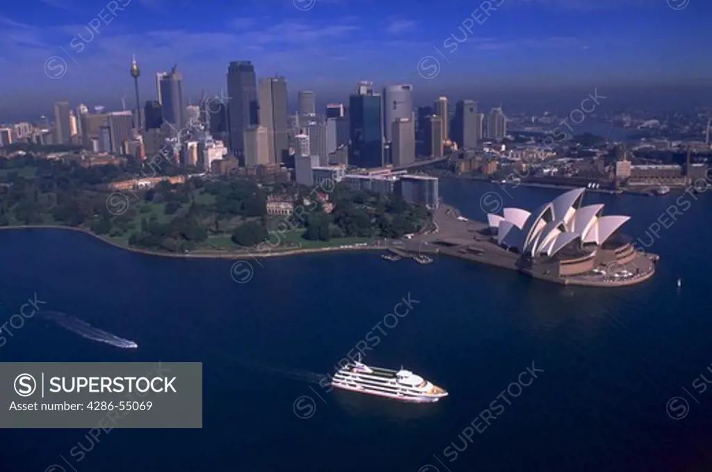 Aerial view of Sydney Opera House and the downtown Sydney skyline, Sydney, Australia.  Cruise ship travels through Sydney Harbor in foreground. Sydney is the site of the 2000 Olympic Games.