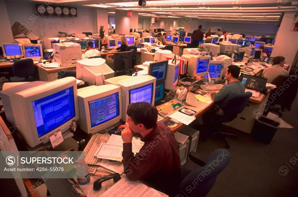 Traders talking on phones while sitting in front of computers in the Fannie MAE Marketroom in Washington, D.C.