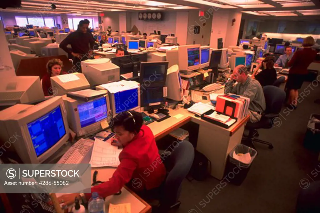 Traders talking on phones while sitting in front of computers in the Fannie MAE Marketroom in Washington, D.C.