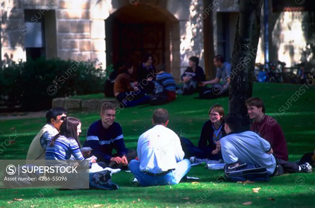 Students sitting on the lawn outside the University of Western Australia, Perth Australia.