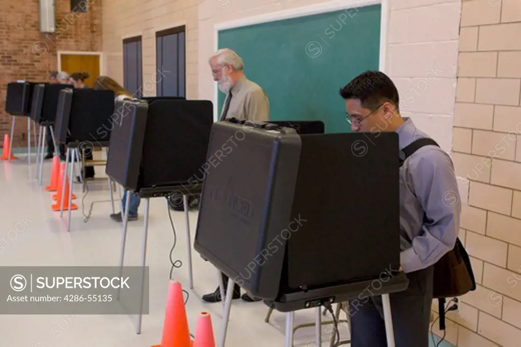 Voters cast ballots in presidential election, using touch screen machines in Arlington, Virginia. 