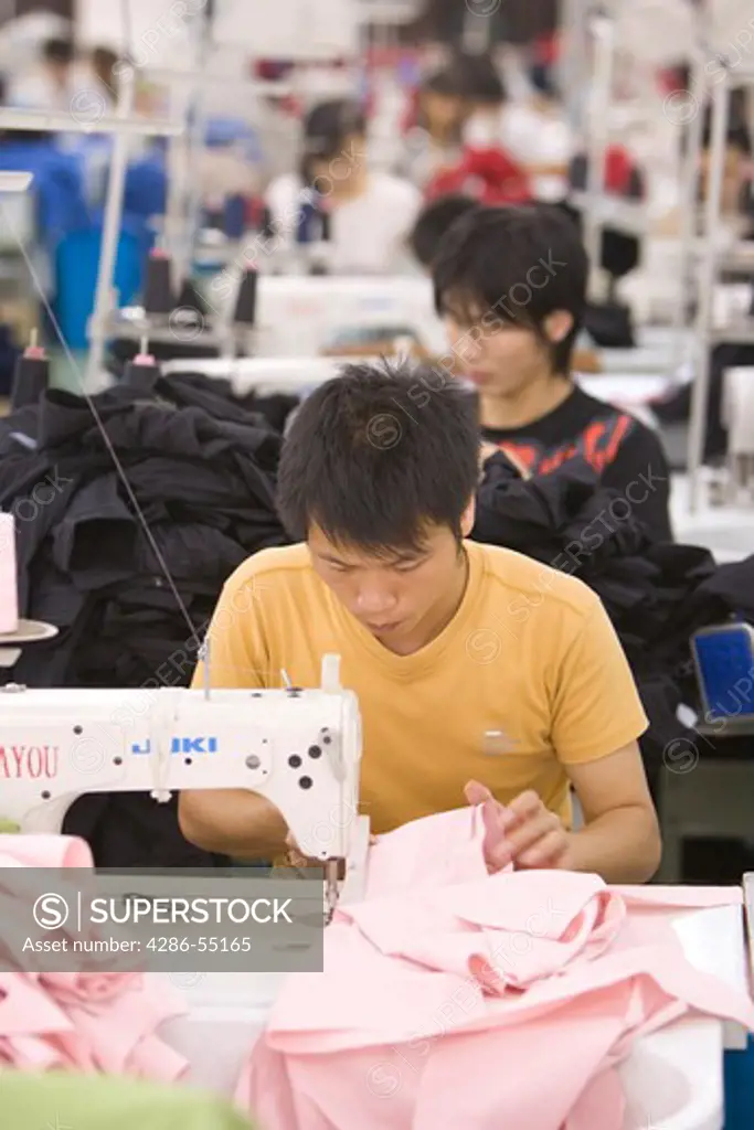 SHENZHEN, GUANGDONG PROVINCE, CHINA - Workers in a garment factory in city of Shenzhen, one of mainland China's first Special Economic Zones, SEZ.
