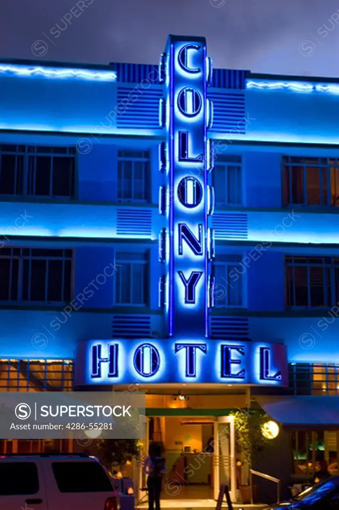 MIAMI BEACH, FLORIDA, USA - Blue neon sign for The Colony Hotel, at night, on Ocean Drive, in the South Beach neighborhood, known for its Art Deco architecture.