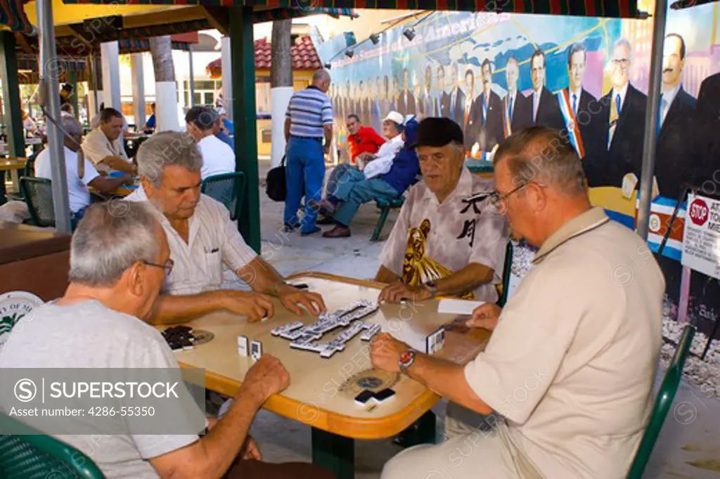 MIAMI, FLORIDA, USA - Elderly Cuban men play dominoes at Maximo Gomez Park, on Calle Ocho (8th Street), the heart of Little Havana.