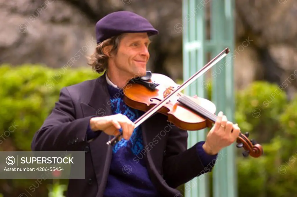 QUEBEC CITY, QUEBEC, CANADA - Jacques Dupuis, traditional Quebec folk music performer, plays violin on Petit Champlain Street, in Old Quebec City.